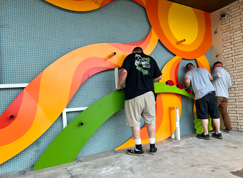 Brandon, Wes, and Ty attaching the arch piece with ladybugs